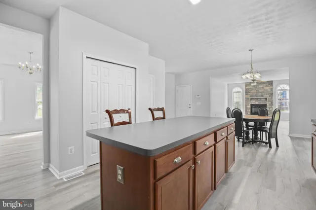 a kitchen that has a table chairs and wooden floor