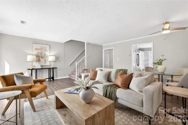 a living room with furniture and wooden floor