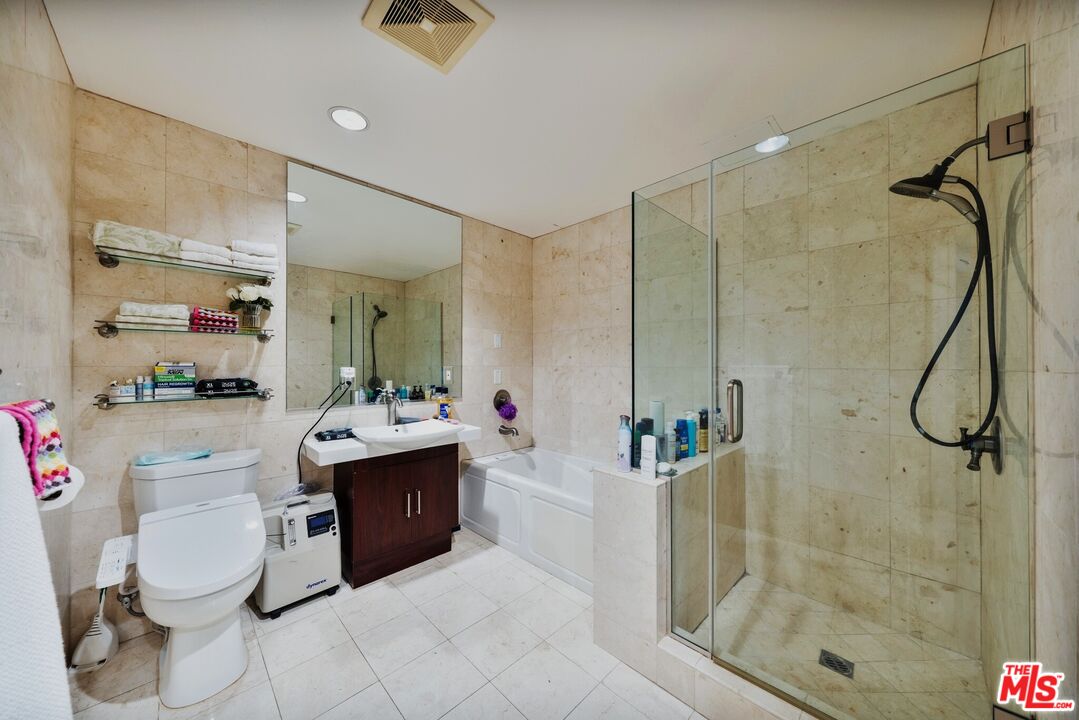 1043 South Kenmore Avenue, Unit 201 Los Angeles, CA 90006 - Photo 11 of 20 a bathroom with a tub sink mirror and shower