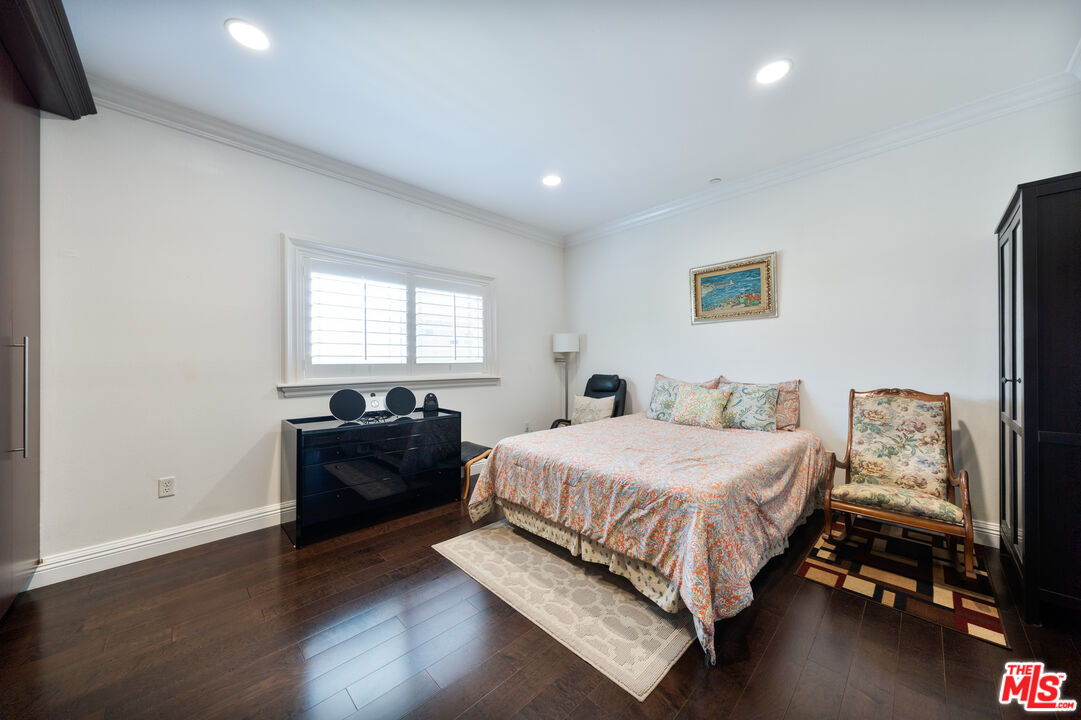 1043 South Kenmore Avenue, Unit 201 Los Angeles, CA 90006 - Photo 12 of 20 a bedroom with a bed and a window