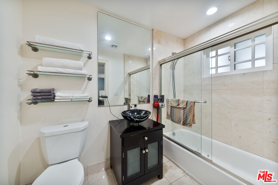 1043 South Kenmore Avenue, Unit 201 Los Angeles, CA 90006 - Photo 13 of 20 a bathroom with a sink a toilet and a shower