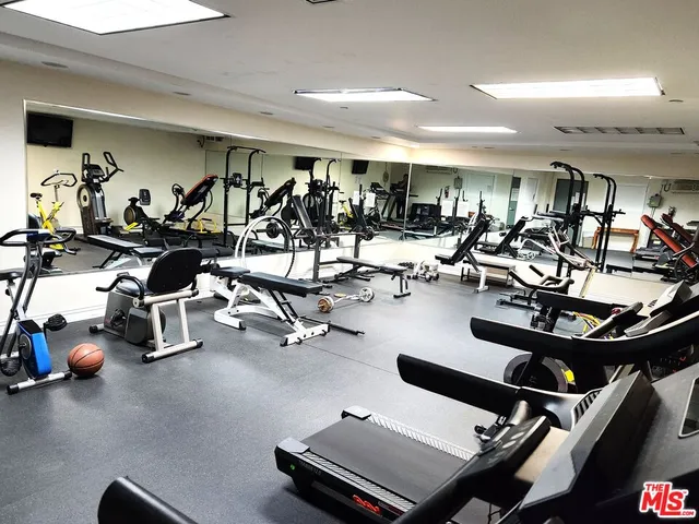 a room with gym equipment and air hockey table