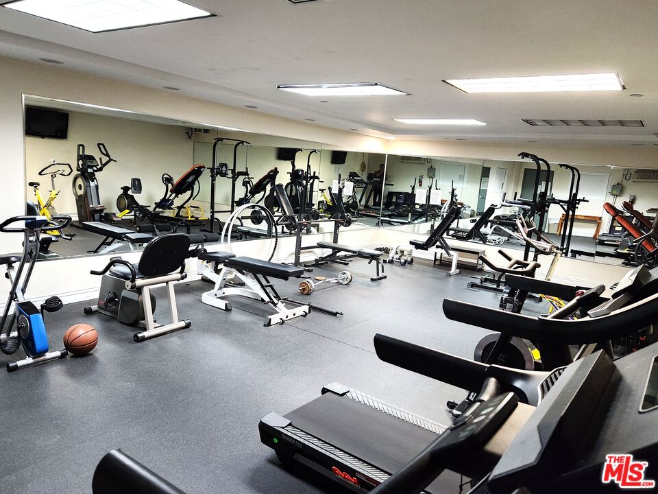 1043 South Kenmore Avenue, Unit 201 Los Angeles, CA 90006 - Photo 16 of 20 a room with gym equipment and air hockey table