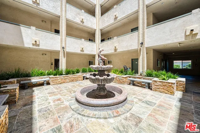 a view of a patio with table and chairs potted plants