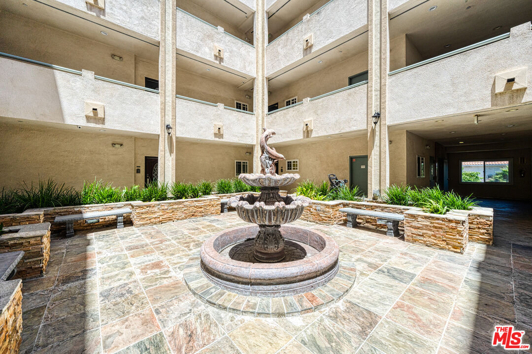 1043 South Kenmore Avenue, Unit 201 Los Angeles, CA 90006 - Photo 2 of 20 a view of a patio with table and chairs potted plants