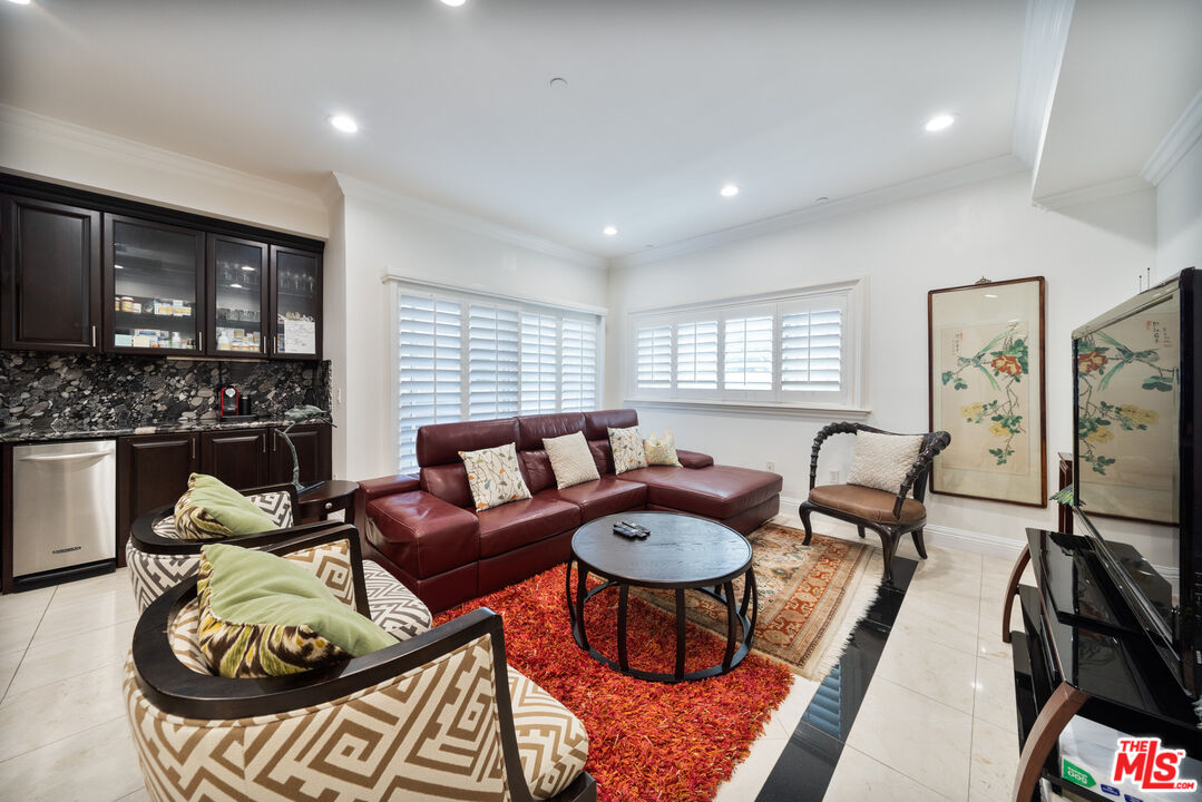 1043 South Kenmore Avenue, Unit 201 Los Angeles, CA 90006 - Photo 5 of 20 a living room with furniture and a flat screen tv