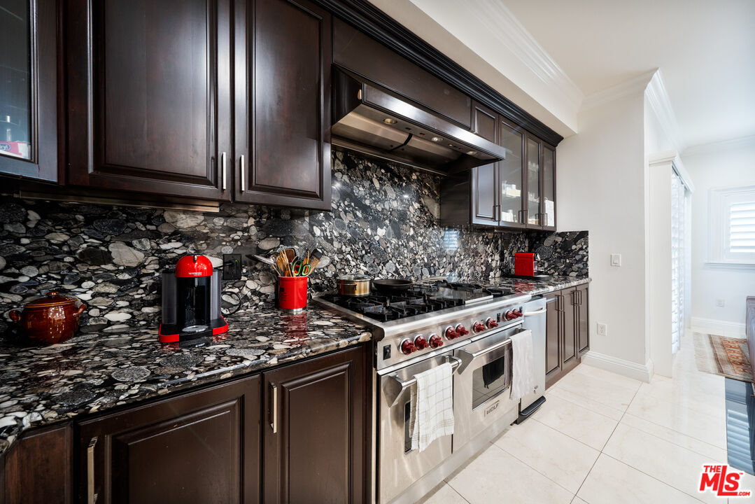 1043 South Kenmore Avenue, Unit 201 Los Angeles, CA 90006 - Photo 9 of 20 a kitchen with stainless steel appliances granite countertop a stove and a sink