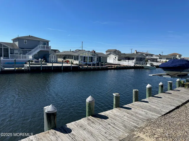 a view of a terrace with lawn chairs