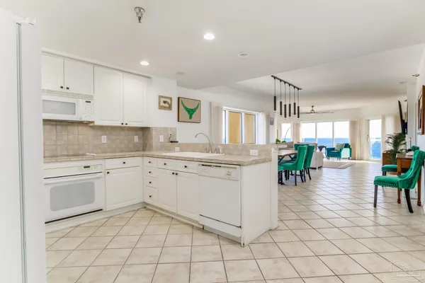 a kitchen with cabinets and chairs