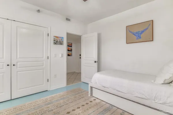 a room with a bed and a painting on the wall