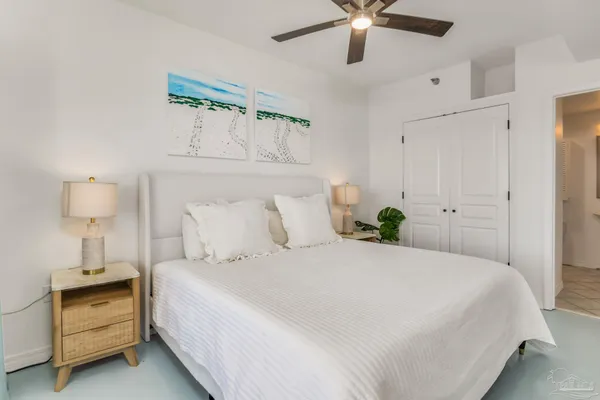 a bedroom with a bed and a ceiling fan
