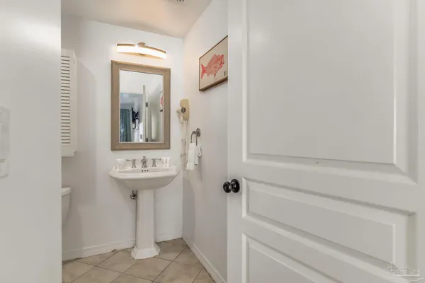 a bathroom with a sink and mirror with toilet