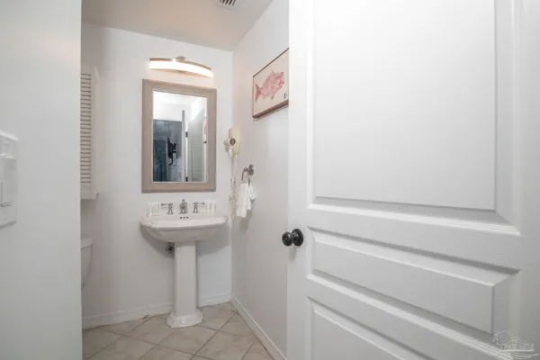 a bathroom with a sink and mirror with toilet
