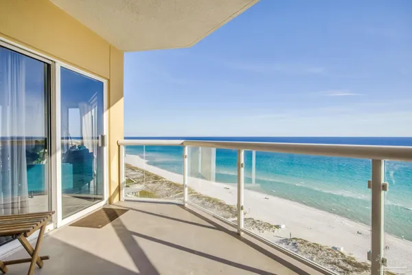 a view of a balcony with floor to ceiling windows