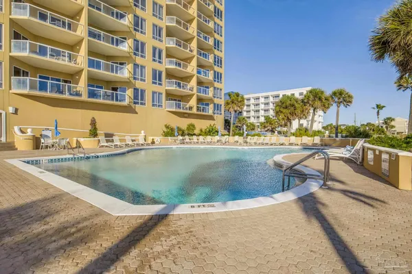 a view of a swimming pool with outdoor seating