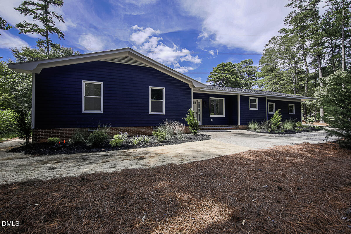 1208 Lorimer Road Raleigh, NC 27606 - Photo 1 of 37 a front view of a house with garden