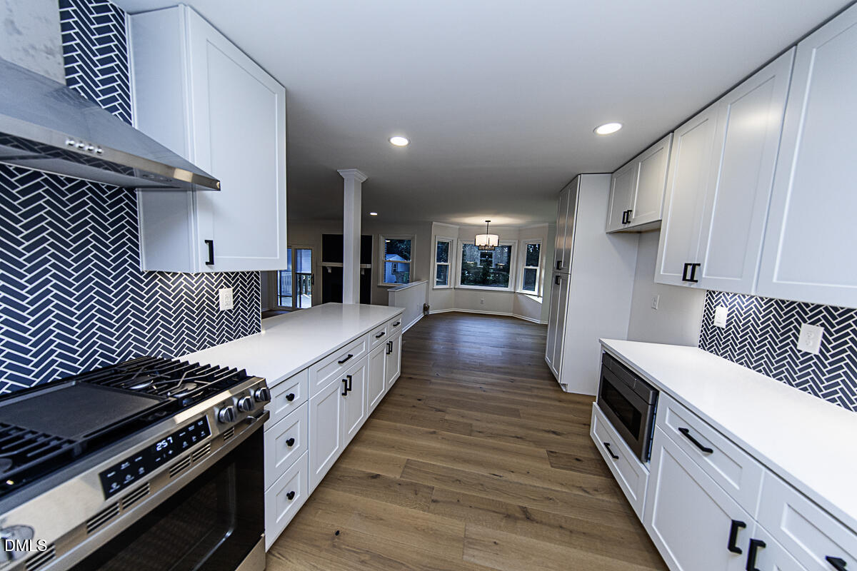 1208 Lorimer Road Raleigh, NC 27606 - Photo 15 of 37 a large kitchen with stainless steel appliances