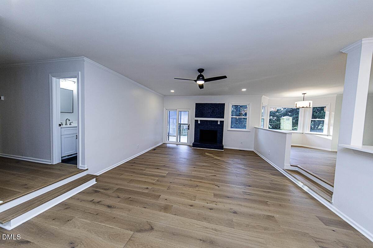 1208 Lorimer Road Raleigh, NC 27606 - Photo 16 of 37 a view of empty room with wooden floor and window