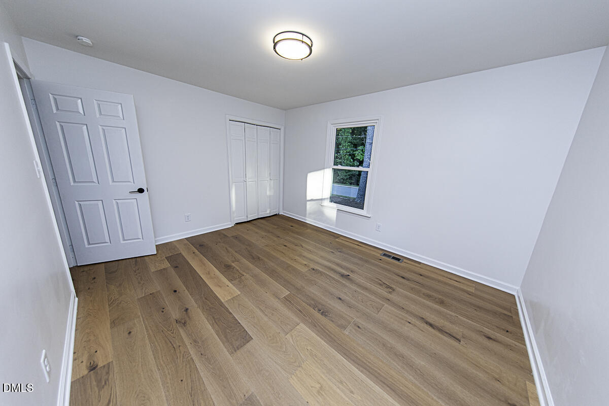 1208 Lorimer Road Raleigh, NC 27606 - Photo 22 of 37 wooden floor in an empty room