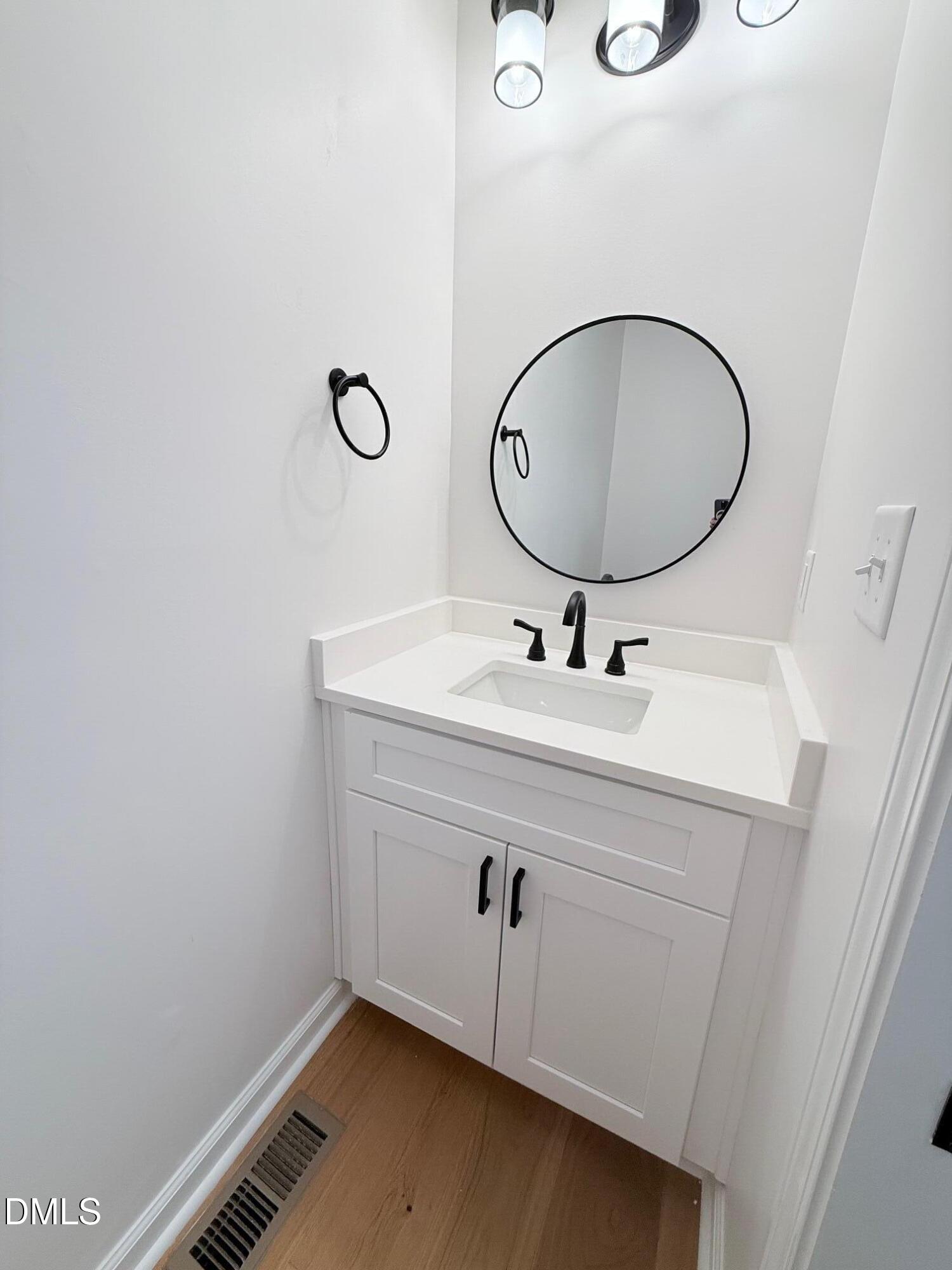1208 Lorimer Road Raleigh, NC 27606 - Photo 28 of 37 a bathroom with a sink mirror and vanity
