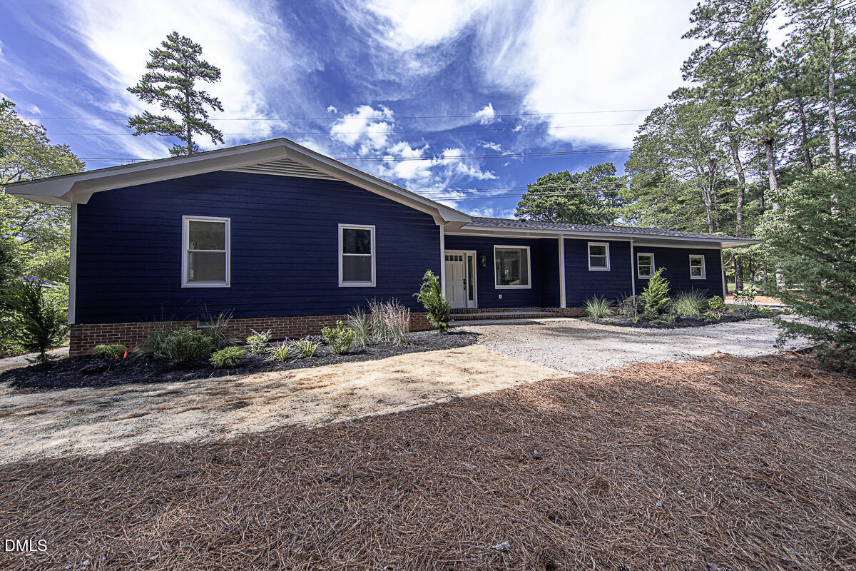 1208 Lorimer Road Raleigh, NC 27606 - Photo 2 of 37 a front view of a house with garden