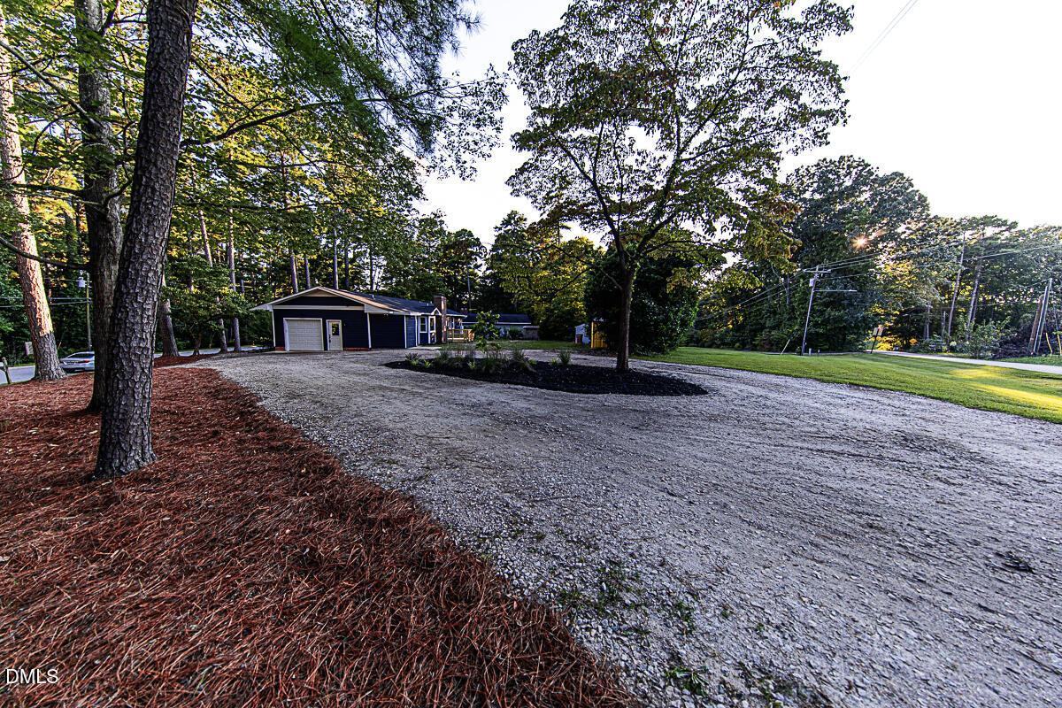 1208 Lorimer Road Raleigh, NC 27606 - Photo 5 of 37 a view of house with backyard and trees