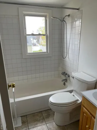 a bathroom with a toilet and a bath tub