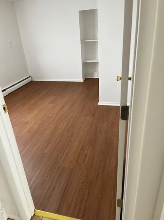 a view of a small space with wooden floor and staircase