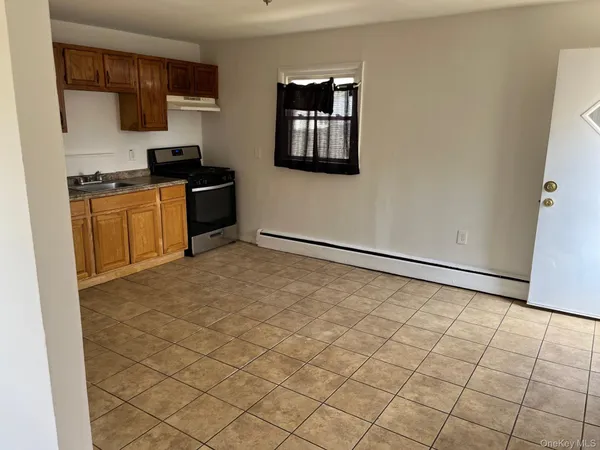 a kitchen with a stove a refrigerator and cabinets