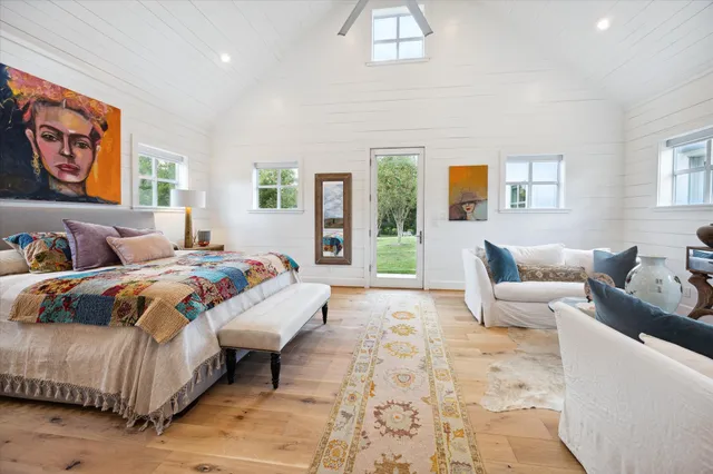 a bedroom with a bed and glass window