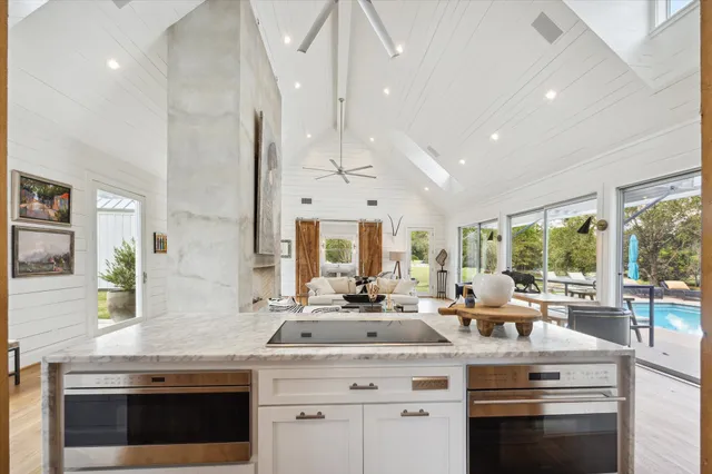 a kitchen with stainless steel appliances granite countertop a stove and a sink