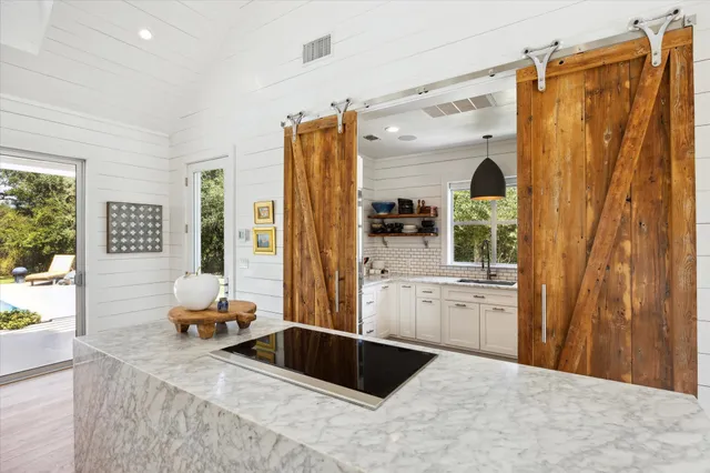 a kitchen with granite countertop a refrigerator and a sink