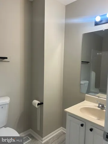 a bathroom with a sink toilet and vanity