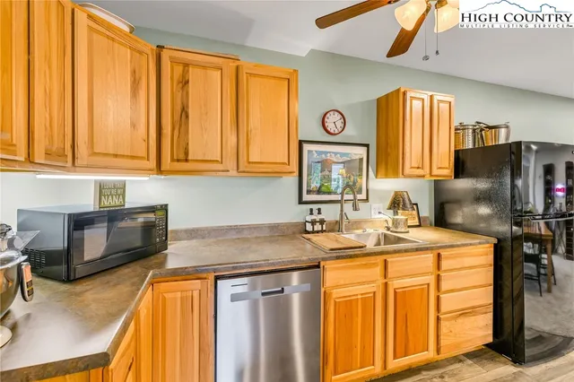 a kitchen with stainless steel appliances granite countertop a sink a stove and refrigerator