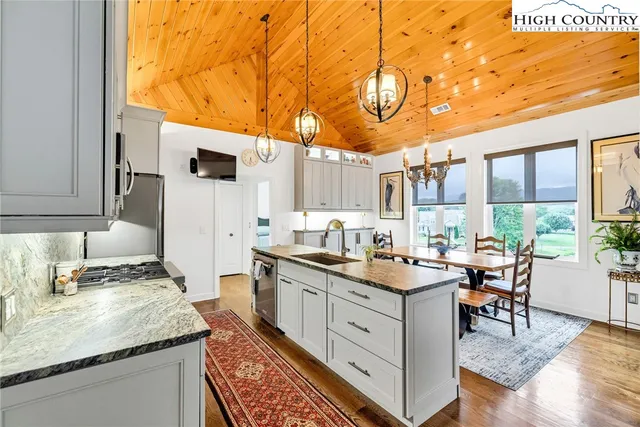 a kitchen with a sink stove and cabinets