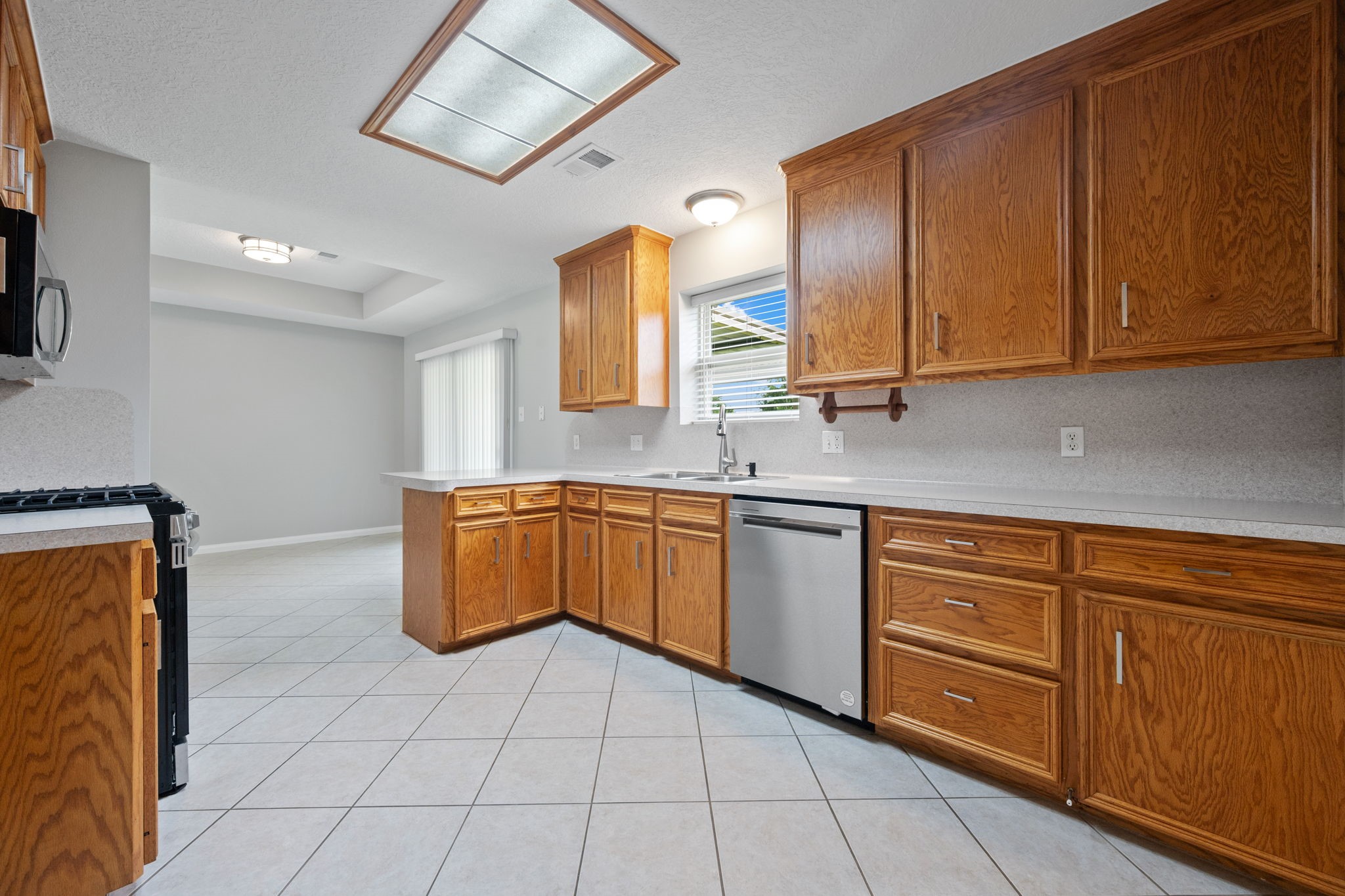 460 West Houston Street Highlands, TX 77562 - Photo 7 of 14 a kitchen with stainless steel appliances granite countertop a sink stove and cabinets