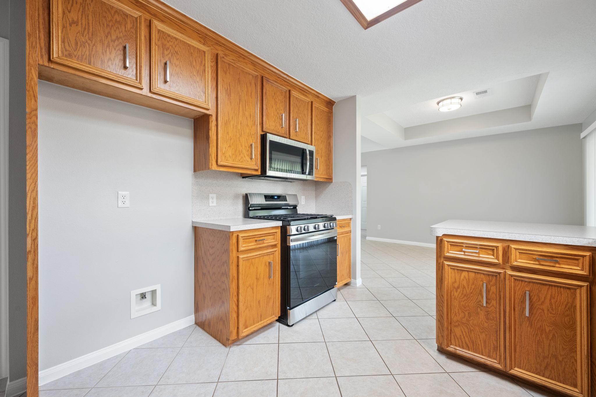 460 West Houston Street Highlands, TX 77562 - Photo 8 of 14 a kitchen with stainless steel appliances granite countertop a stove a sink and a microwave