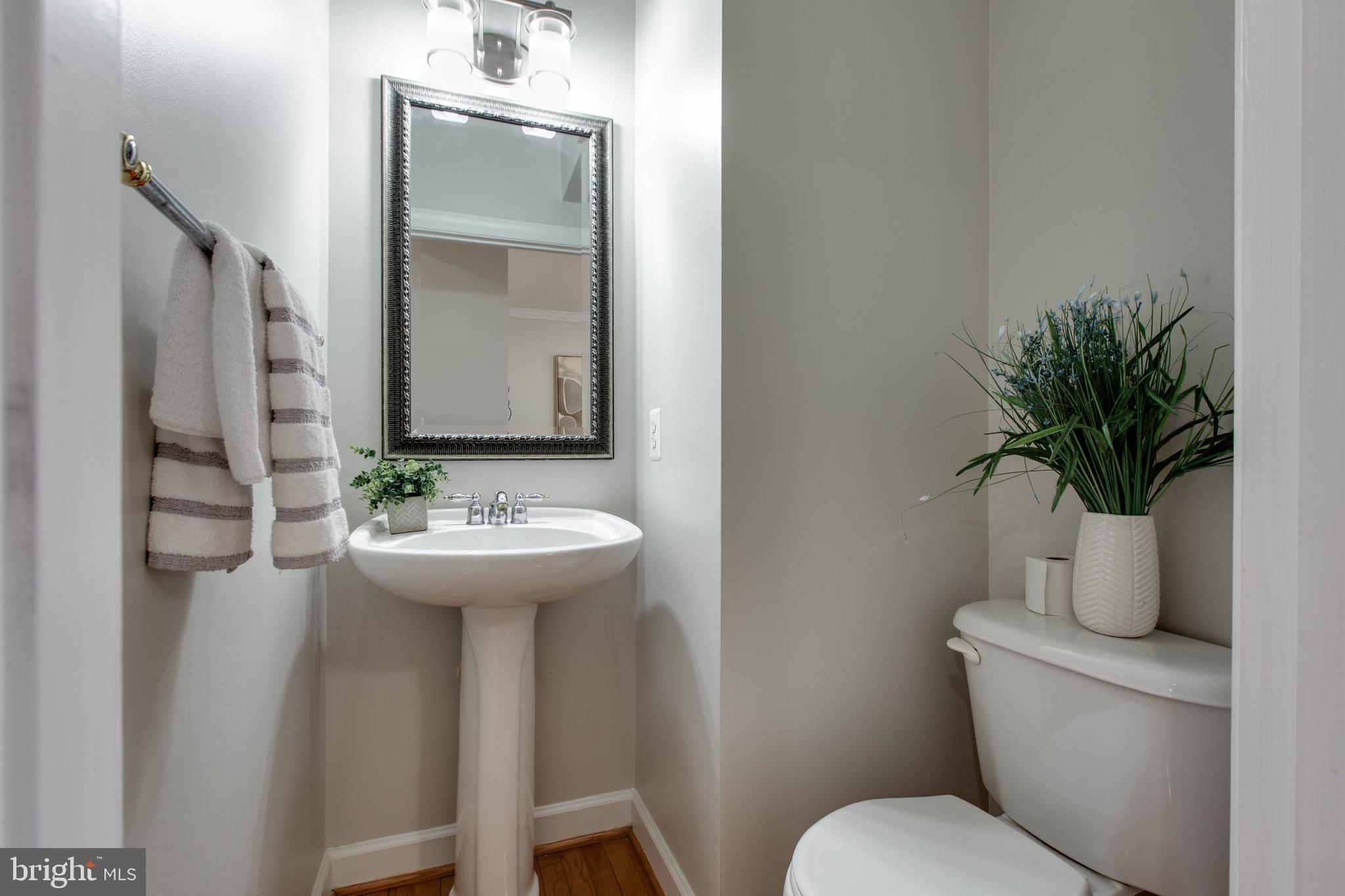 1506 Penzance Way Hanover, MD 21076 - Photo 15 of 53 a bathroom with a toilet a sink and mirror
