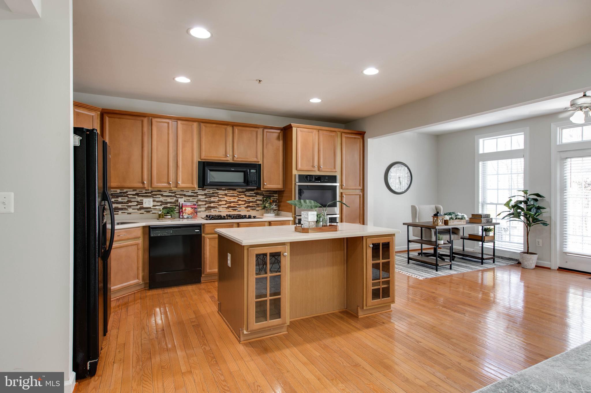 1506 Penzance Way Hanover, MD 21076 - Photo 23 of 53 a kitchen with stainless steel appliances granite countertop wooden cabinets a sink a stove a dining table and chairs