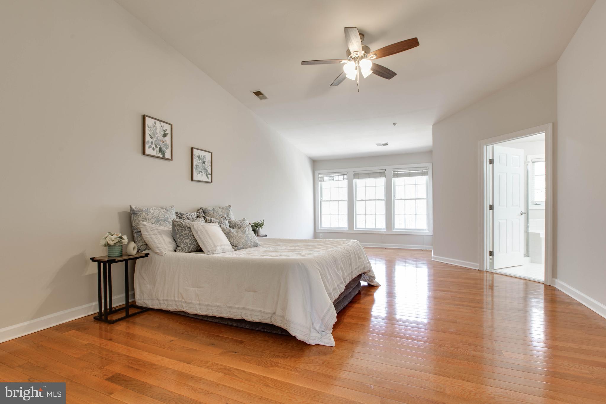 1506 Penzance Way Hanover, MD 21076 - Photo 28 of 53 a spacious bedroom with a bed and a chandelier