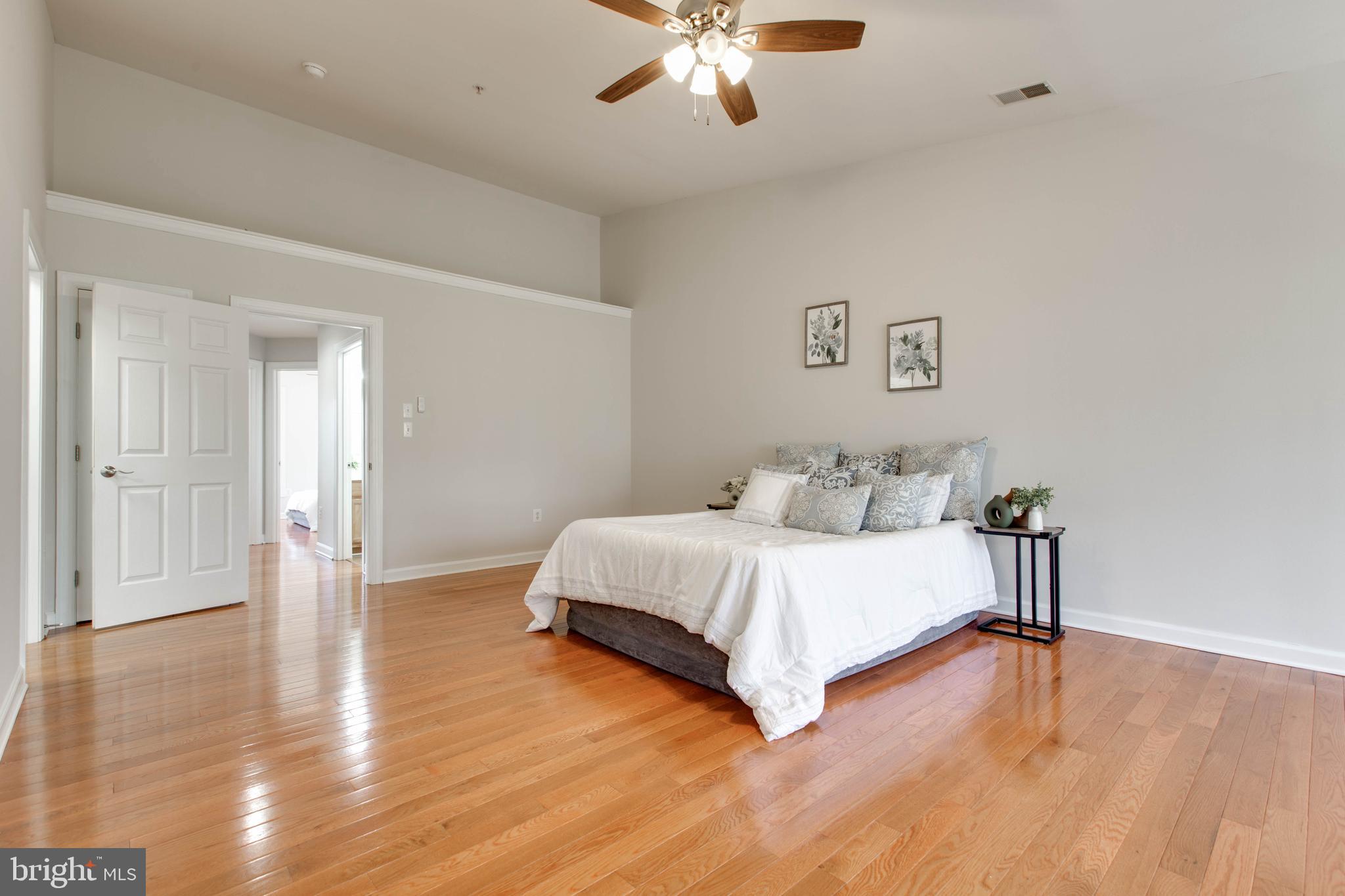1506 Penzance Way Hanover, MD 21076 - Photo 31 of 53 a spacious bedroom with a bed and a chandelier