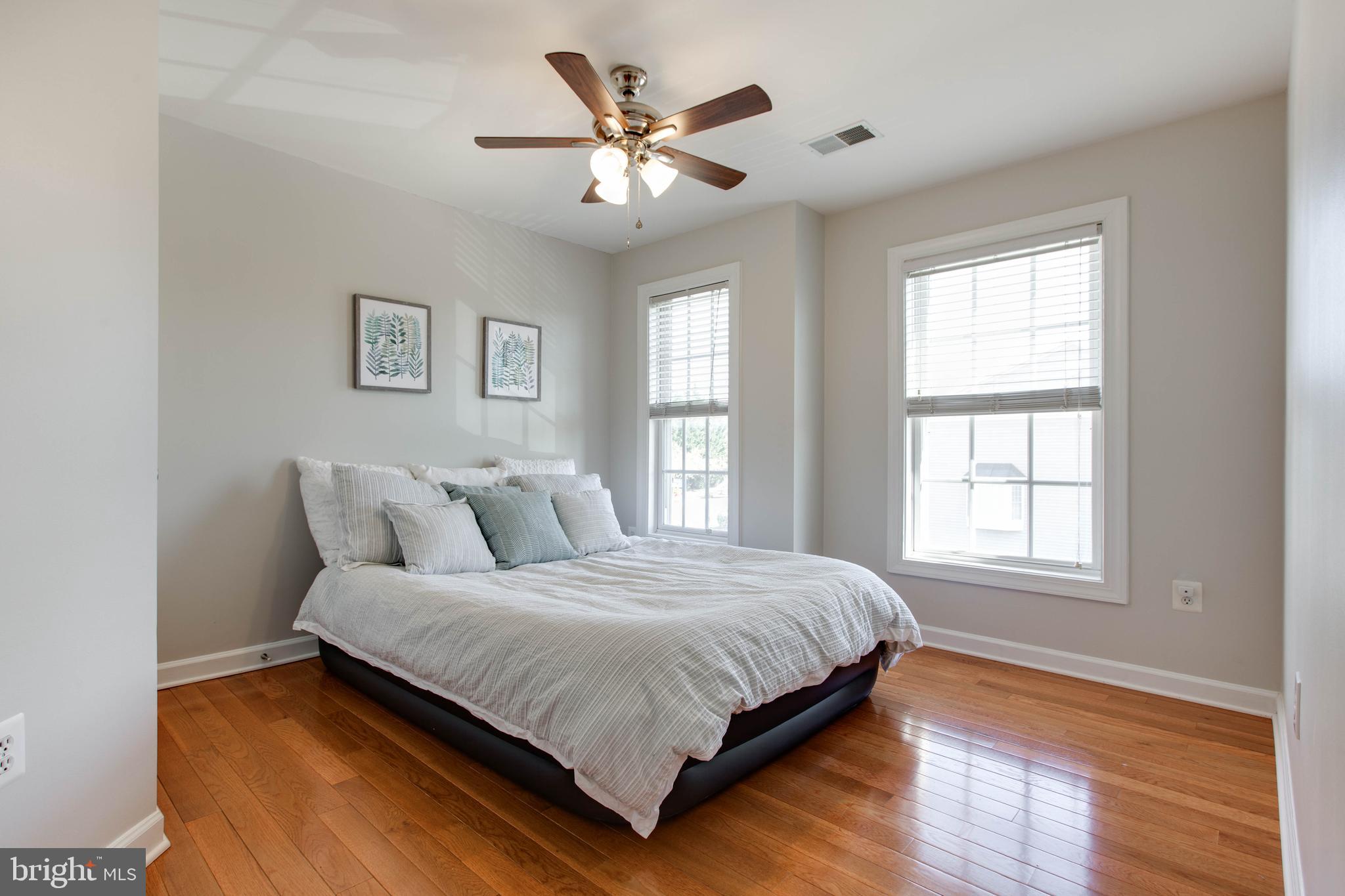 1506 Penzance Way Hanover, MD 21076 - Photo 35 of 53 a bedroom with a large bed chandelier and a window