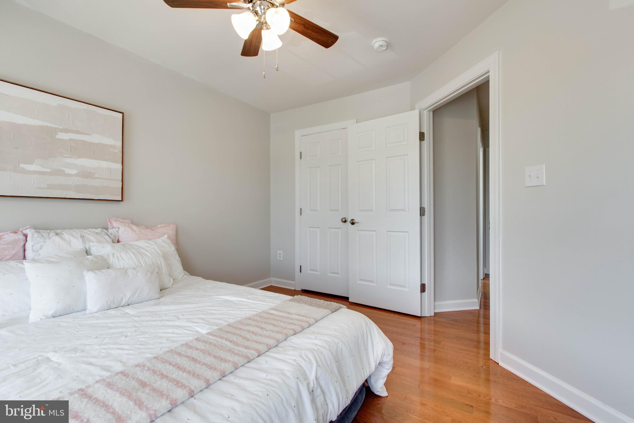1506 Penzance Way Hanover, MD 21076 - Photo 41 of 53 a bedroom with a large bed and a chandelier