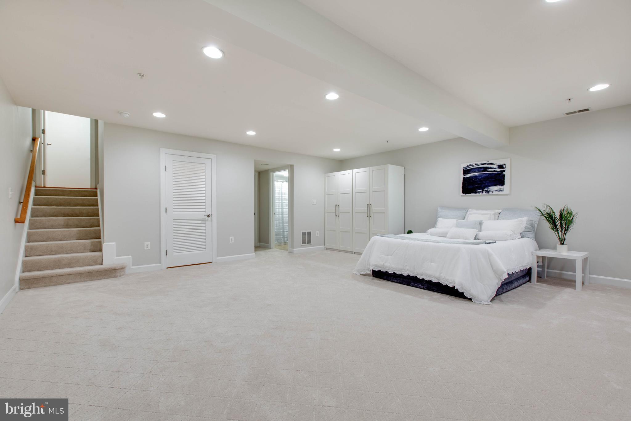 1506 Penzance Way Hanover, MD 21076 - Photo 48 of 53 a spacious bedroom with a bed and a couch