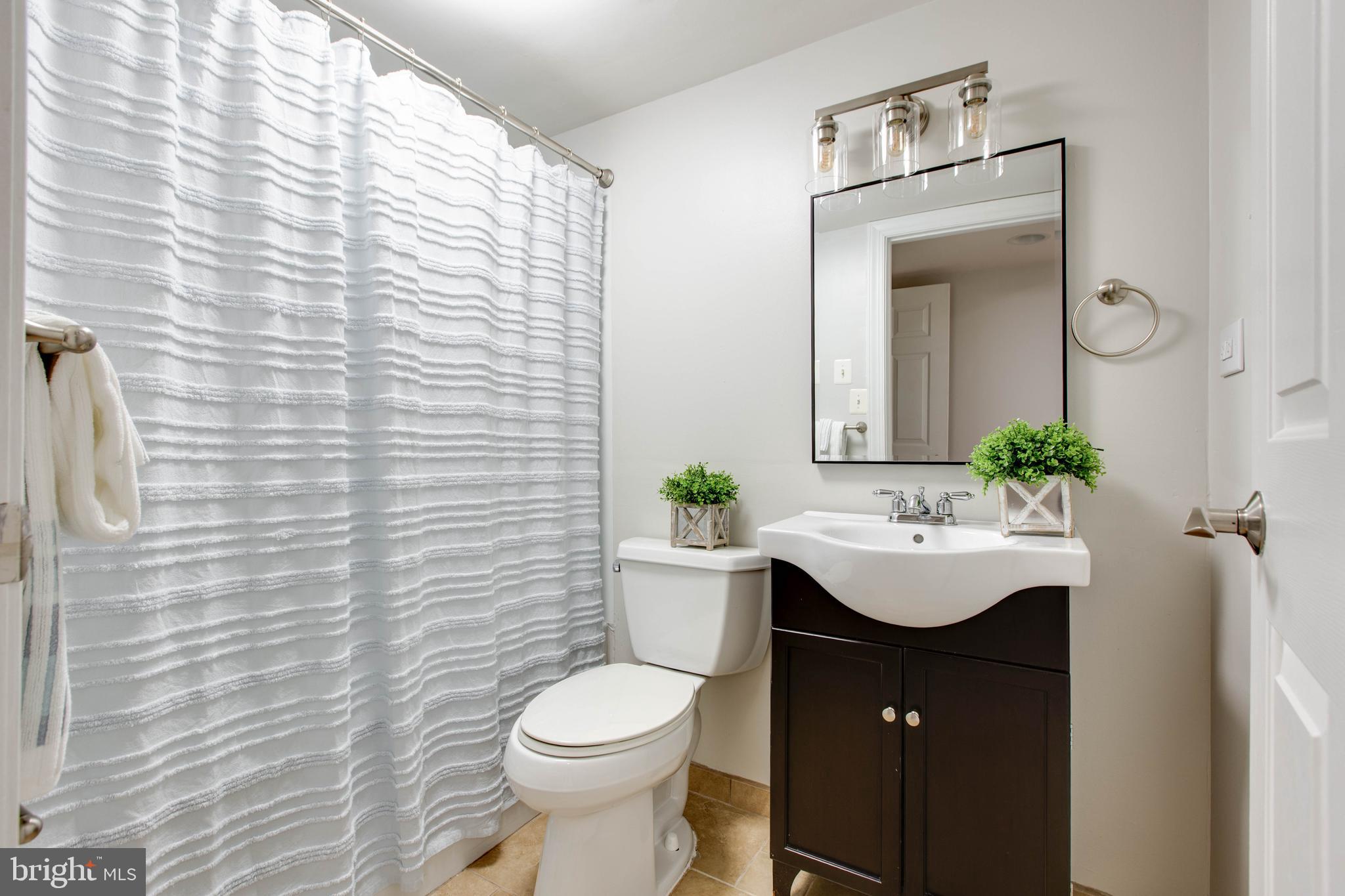 1506 Penzance Way Hanover, MD 21076 - Photo 49 of 53 a bathroom with a sink a toilet and mirror