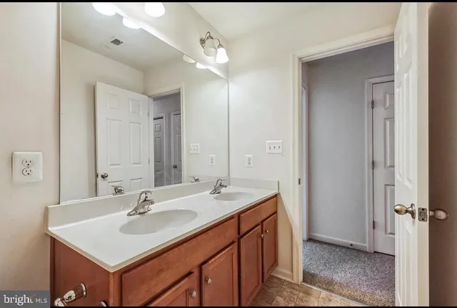 a bathroom with a sink vanity and a mirror