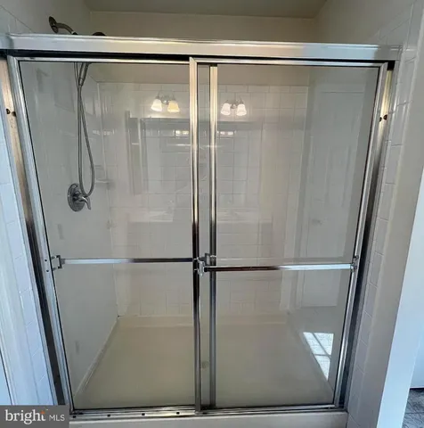 a bathroom with a glass shower door
