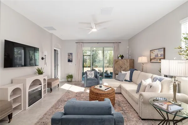 a dining room with wooden floor a chandelier a wooden table and chairs
