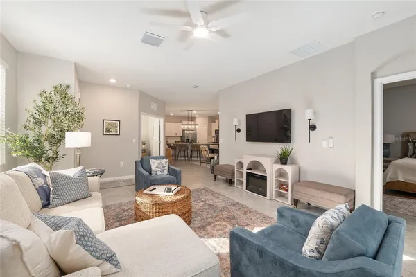 a kitchen with stainless steel appliances kitchen island granite countertop a refrigerator a stove a microwave oven a sink with island and chairs