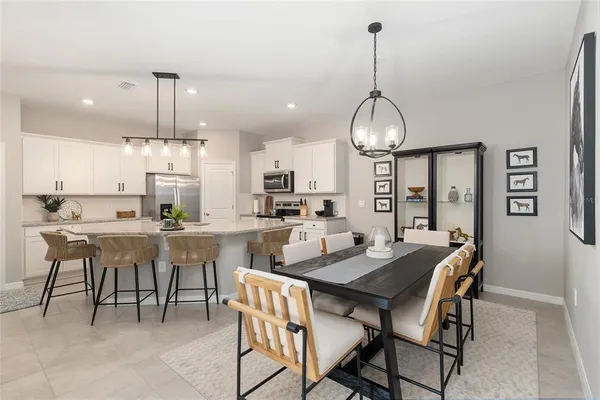a kitchen with a sink dishwasher and white cabinets with wooden floor